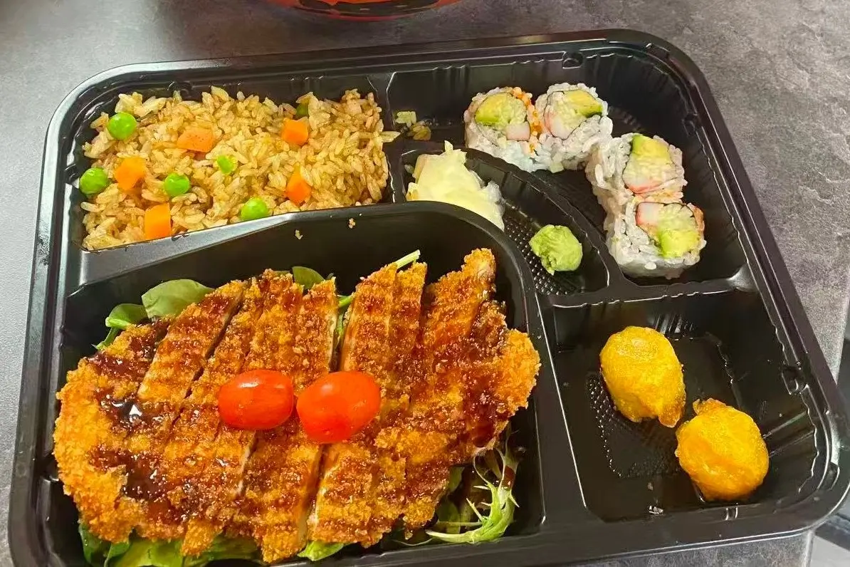 Bento box with chicken katsu, fried rice, sushi rolls and side dishes at Dharma Sushi & Grill, a Japanese Restaurant in Schenectady